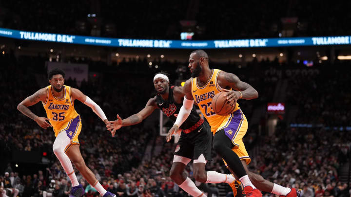 Nov 17, 2023; Portland, Oregon, USA; Los Angeles Lakers small forward LeBron James (23) dribbles the ball while defended by Portland Trail Blazers small forward Jerami Grant (9) during the second half at Moda Center. Mandatory Credit: Soobum Im-USA TODAY Sports