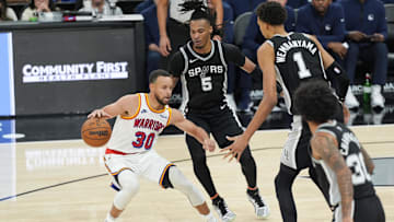 Nov 23, 2024; San Antonio, Texas, USA;  Golden State Warriors guard Stephen Curry (30) dribbles in front of San Antonio Spurs guard Stephon Castle (5) and center Victor Wembanyama (1) in the second half at Frost Bank Center. Mandatory Credit: Daniel Dunn-Imagn Images