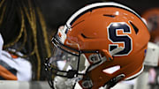 Nov 20, 2021; Raleigh, North Carolina, USA; A Syracuse Orange helmet rests on a warmer during the second half at the game between the Syracuse Orange and the North Carolina State Wolfpack at Carter-Finley Stadium. Mandatory Credit: William Howard-Imagn Images