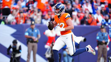 Dec 15, 2024; Denver, Colorado, USA; Denver Broncos tight end Adam Trautman (82) scores a touchdown against the Indianapolis Colts at Empower Field at Mile High. Mandatory Credit: Ron Chenoy-Imagn Images