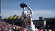 While at Houston in 2023, Sam Brown (13) leaps to catch a touchdown against the Navy Midshipmen.