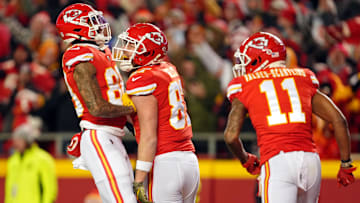 Kansas City Chiefs tight end Travis Kelce (center) celebrates with tight end Jody Fortson (left) after scoring a touchdown against the Cincinnati Bengals during the second quarter of the AFC Championship game at GEHA Field at Arrowhead Stadium.