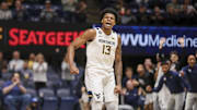 Feb 11, 2025; Morgantown, West Virginia, USA; West Virginia Mountaineers forward Amani Hansberry (13) celebrates during the first half against the Brigham Young Cougars at WVU Coliseum. Mandatory Credit: Ben Queen-Imagn Images