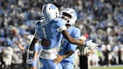 Nov 8, 2025; Chapel Hill, North Carolina, USA; North Carolina Tar Heels wide receiver Jordan Shipp (1) celebrates with quarterback Gio Lopez (7) after scoring a touchdown in the fourth quarter at Kenan Stadium. Mandatory Credit: Bob Donnan-Imagn Images