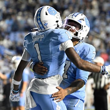 Nov 8, 2025; Chapel Hill, North Carolina, USA; North Carolina Tar Heels wide receiver Jordan Shipp (1) celebrates with quarterback Gio Lopez (7) after scoring a touchdown in the fourth quarter at Kenan Stadium. Mandatory Credit: Bob Donnan-Imagn Images