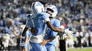 Nov 8, 2025; Chapel Hill, North Carolina, USA; North Carolina Tar Heels wide receiver Jordan Shipp (1) celebrates with quarterback Gio Lopez (7) after scoring a touchdown in the fourth quarter at Kenan Stadium. Mandatory Credit: Bob Donnan-Imagn Images