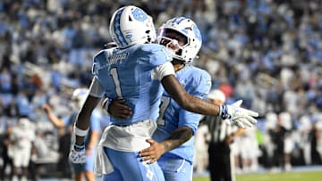 Nov 8, 2025; Chapel Hill, North Carolina, USA; North Carolina Tar Heels wide receiver Jordan Shipp (1) celebrates with quarterback Gio Lopez (7) after scoring a touchdown in the fourth quarter at Kenan Stadium. Mandatory Credit: Bob Donnan-Imagn Images