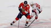 Nov 25, 2024; Sunrise, Florida, USA; Florida Panthers center Aleksander Barkov (16) moves the puck ahed of Washington Capitals center Nic Dowd (26) during the third period at Amerant Bank Arena. Mandatory Credit: Sam Navarro-Imagn Images