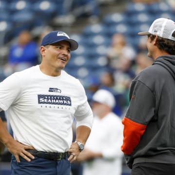 Aug 24, 2024; Seattle, Washington, USA; Seattle Seahawks head coach Mike Macdonald talks with a member of the Cleveland Browns staff during pregame warmups at Lumen Field. Mandatory Credit: Joe Nicholson-USA TODAY Sports