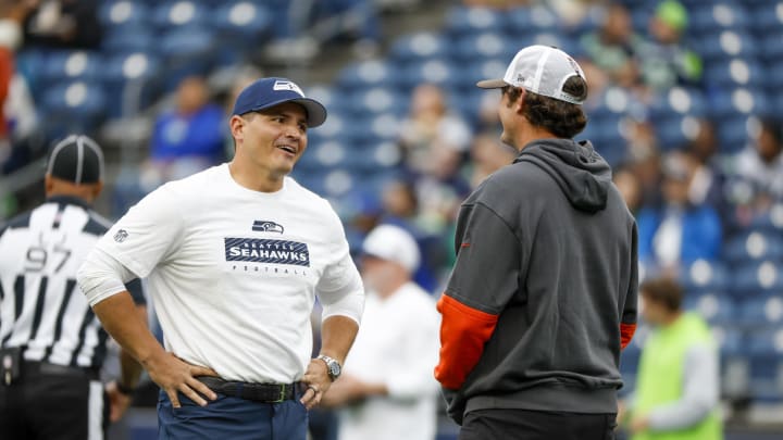 Aug 24, 2024; Seattle, Washington, USA; Seattle Seahawks head coach Mike Macdonald talks with a member of the Cleveland Browns staff during pregame warmups at Lumen Field. Mandatory Credit: Joe Nicholson-USA TODAY Sports