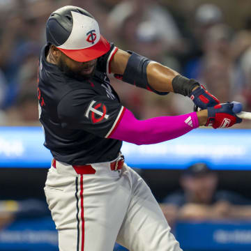 Minnesota Twins left fielder Manuel Margot (13) hits a double against the Atlanta Braves in the first inning at Target Field in Minneapolis on Aug. 26, 2024.