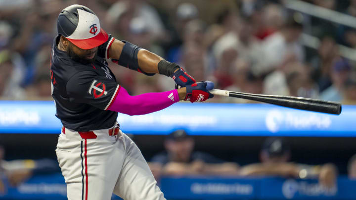 Minnesota Twins left fielder Manuel Margot (13) hits a double against the Atlanta Braves in the first inning at Target Field in Minneapolis on Aug. 26, 2024.