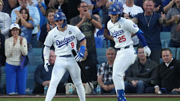 Oct 26, 2024; Los Angeles, California, USA; Los Angeles Dodgers shortstop Tommy Edman (25) reacts with outfielder Enrique Hernandez (8) after hitting a home run against the New York Yankees in the second inning for game two of the 2024 MLB World Series at Dodger Stadium. Mandatory Credit: Kirby Lee-Imagn Images