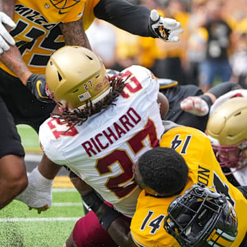 Sep 14, 2024; Columbia, Missouri, USA; Missouri Tigers linebacker Triston Newson (14) looses his helmet while tackling Boston College Eagles running back Turbo Richard (27) during the first half at Faurot Field at Memorial Stadium. Mandatory Credit: Denny Medley-Imagn Images