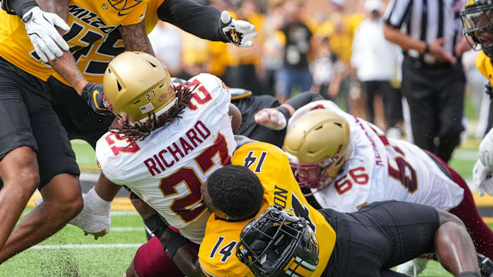 Sep 14, 2024; Columbia, Missouri, USA; Missouri Tigers linebacker Triston Newson (14) looses his helmet while tackling Boston College Eagles running back Turbo Richard (27) during the first half at Faurot Field at Memorial Stadium. Mandatory Credit: Denny Medley-Imagn Images