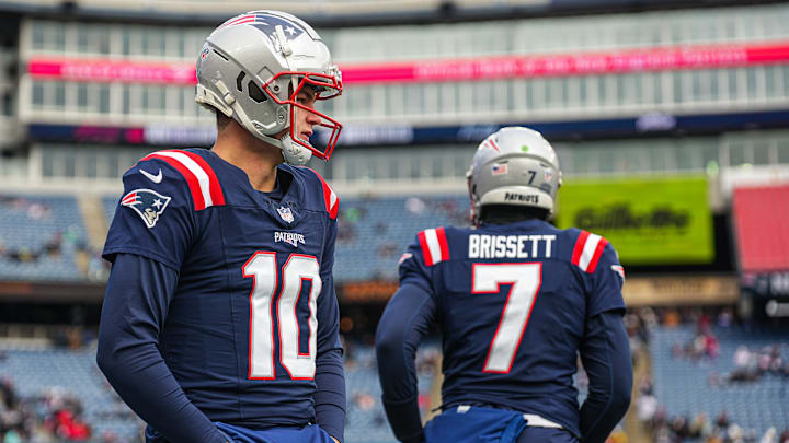 Jan 5, 2025; Foxborough, Massachusetts, USA; New England Patriots quarterback Drake Maye (10) and quarterback Jacoby Brissett (7) warm up before the start of the game against the Buffalo Bills at Gillette Stadium. Mandatory Credit: David Butler II-Imagn Images
