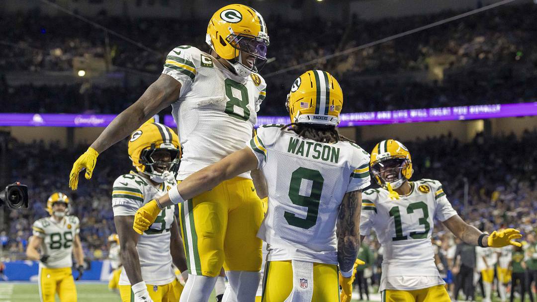 Nov 27, 2025; Detroit, Michigan, USA; Green Bay Packers running back Josh Jacobs (8) and Green Bay Packers wide receiver Christian Watson (9) celebrate after a touchdown against the Detroit Lions during the third quarter at Ford Field. Mandatory Credit: David Reginek-Imagn Images