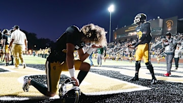 Oct 20, 2023; Carrollton, GA, USA; Carrollton Trojans quarterback Julian Lewis (10) kneels in the