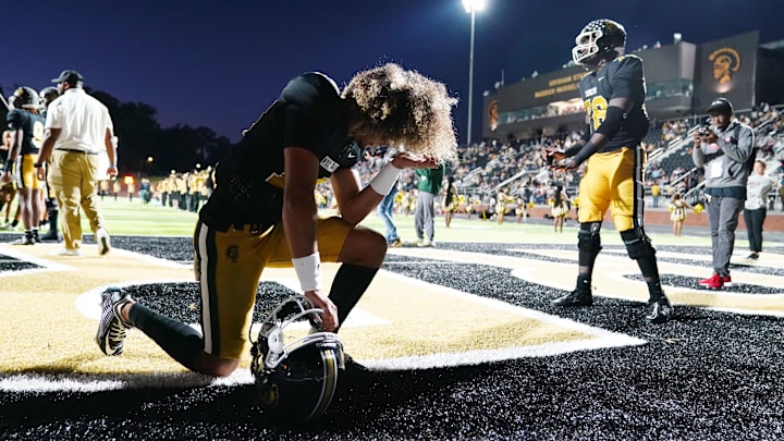 Oct 20, 2023; Carrollton, GA, USA; Carrollton Trojans quarterback Julian Lewis (10) kneels in the end zone before their game against the Westlake Lions at Grisham Stadium. The 15-year-old Carrollton High student has already committed to playing for the University of Southern California Trojans and has been considered one of the top high school quarterback prospects. Mandatory Credit: John David Mercer-Imagn Images
