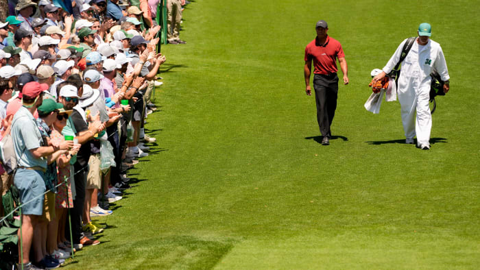 Apr 14, 2024; Augusta, Georgia, USA; Tiger Woods and his caddie, Lance Bennett, walk to the No. 18