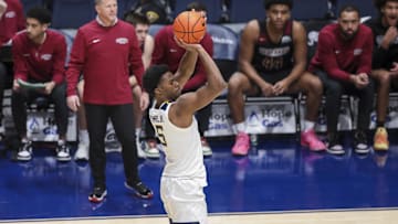 Nov 17, 2025; Morgantown, West Virginia, USA; West Virginia Mountaineers forward DJ Thomas (5) shoots a three-point shot during the first half against the Lafayette Leopards at WVU Coliseum. Mandatory Credit: Ben Queen-Imagn Images