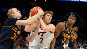 Mar 11, 2025; Charlotte, NC, USA; Virginia Tech Hokies guard Jaden Schutt (2) with the ball as California Golden Bears forward Rytis Petraitis (31) and guard DJ Campbell (3) defend in overtime at Spectrum Center. Mandatory Credit: Bob Donnan-Imagn Images