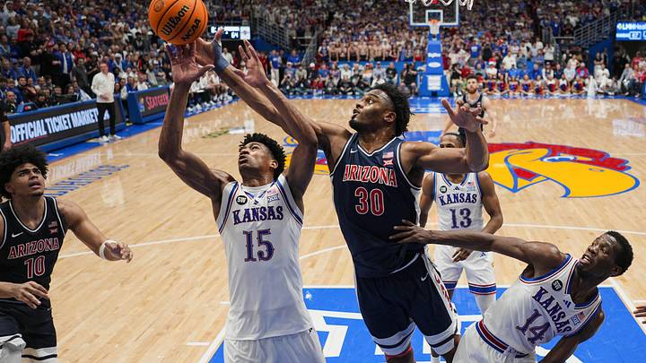 Feb 9, 2026; Lawrence, Kansas, USA; Kansas Jayhawks forward Bryson Tiller (15) and Arizona Wildcats forward Tobe Awaka (30) fight for a rebound during the second half at Allen Fieldhouse. Mandatory Credit: Jay Biggerstaff-Imagn Images