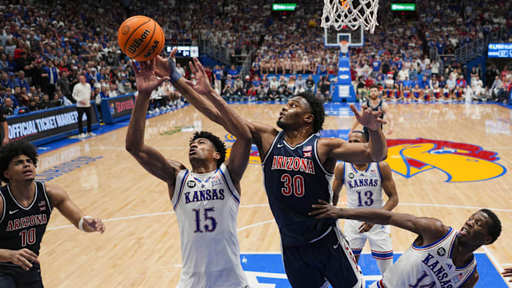 Feb 9, 2026; Lawrence, Kansas, USA; Kansas Jayhawks forward Bryson Tiller (15) and Arizona Wildcats forward Tobe Awaka (30) fight for a rebound during the second half at Allen Fieldhouse. Mandatory Credit: Jay Biggerstaff-Imagn Images
