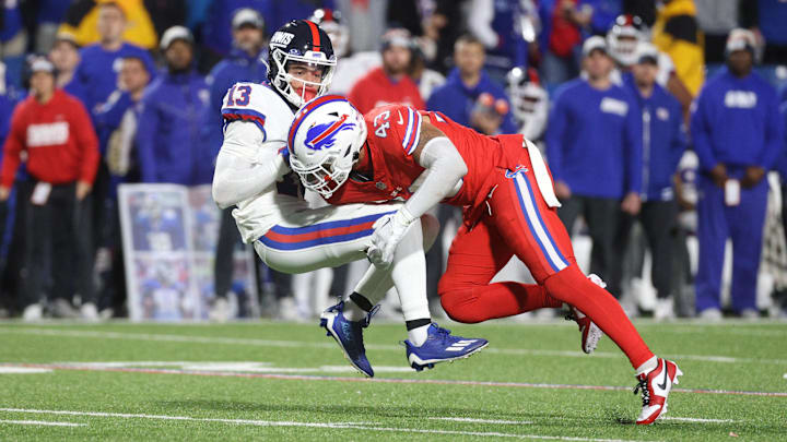 Buffalo Bills linebacker Terrel Bernard (43) hits New York Giants wide receiver Jalin Hyatt (13) just as he catches the ball.