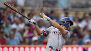 Jun 10, 2025; Minneapolis, Minnesota, USA; Texas Rangers center fielder Evan Carter (32) hits a single against the Minnesota Twins in the fifth inning at Target Field.