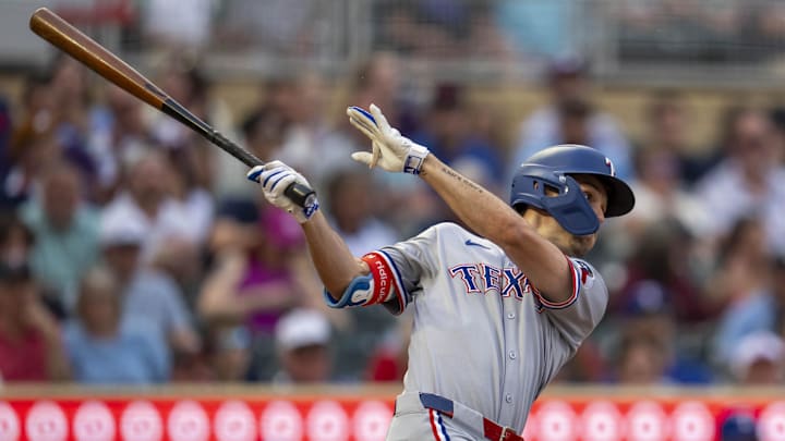 Jun 10, 2025; Minneapolis, Minnesota, USA; Texas Rangers center fielder Evan Carter (32) hits a single against the Minnesota Twins in the fifth inning at Target Field. Jun 10, 2025; Minneapolis, Minnesota, USA; Texas Rangers center fielder Evan Carter (32) hits a single against the Minnesota Twins in the fifth inning at Target Field.