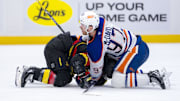 Jan 18, 2025; Vancouver, British Columbia, CAN; Edmonton Oilers forward Connor McDavid (97) battles with Vancouver Canucks forward Conor Garland (8) in the third period at Rogers Arena. Mandatory Credit: Bob Frid-Imagn Images