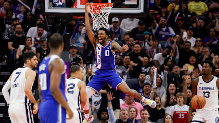 Mar 18, 2024; Sacramento, California, USA; Sacramento Kings guard Malik Monk (0) dunks the ball during the fourth quarter against the Memphis Grizzlies at Golden 1 Center. Mandatory Credit: Sergio Estrada-Imagn Images