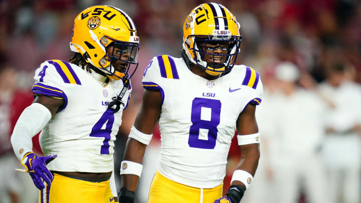 Nov 4, 2023; Tuscaloosa, Alabama, USA; LSU Tigers linebacker Harold Perkins Jr. (4) and safety Major Burns (8) reacts after sacking Alabama Crimson Tide quarterback Jalen Milroe (not pictured) during the first quarter at Bryant-Denny Stadium. Mandatory Credit: John David Mercer-USA TODAY Sports