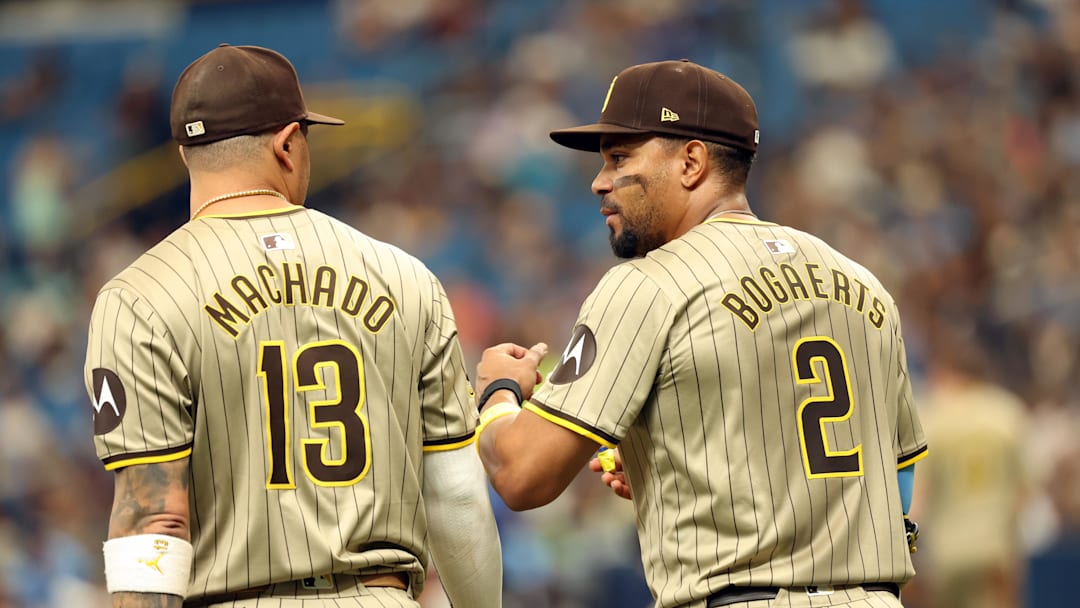 Sep 1, 2024; St. Petersburg, Florida, USA;  San Diego Padres third base Manny Machado (13) and second base Xander Bogaerts (2) talk during the second inning against the Tampa Bay Rays at Tropicana Field. Mandatory Credit: Kim Klement Neitzel-Imagn Images