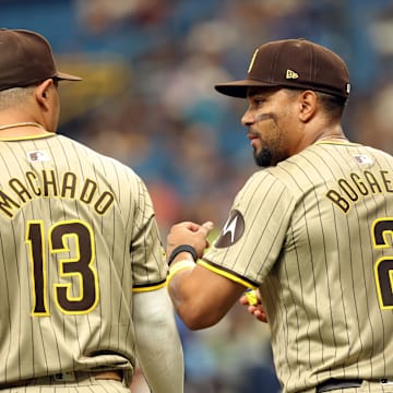 Sep 1, 2024; St. Petersburg, Florida, USA;  San Diego Padres third base Manny Machado (13) and second base Xander Bogaerts (2) talk during the second inning against the Tampa Bay Rays at Tropicana Field. Mandatory Credit: Kim Klement Neitzel-Imagn Images