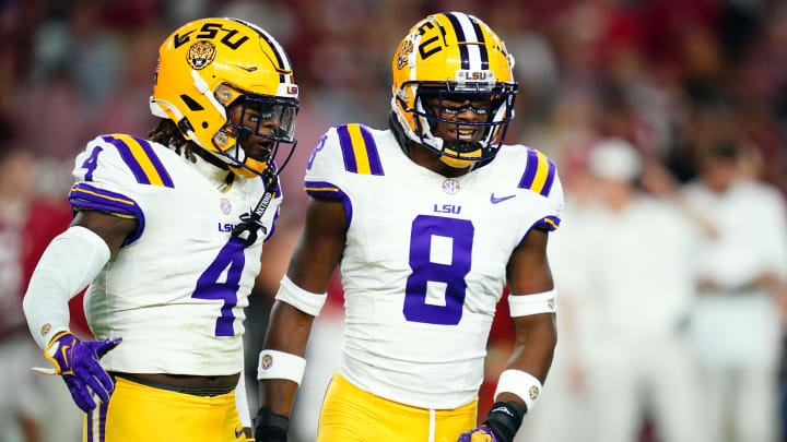 Nov 4, 2023; Tuscaloosa, Alabama, USA; LSU Tigers linebacker Harold Perkins Jr. (4) and safety Major Burns (8) reacts after sacking Alabama Crimson Tide quarterback Jalen Milroe (not pictured) during the first quarter at Bryant-Denny Stadium. Mandatory Credit: John David Mercer-USA TODAY Sports