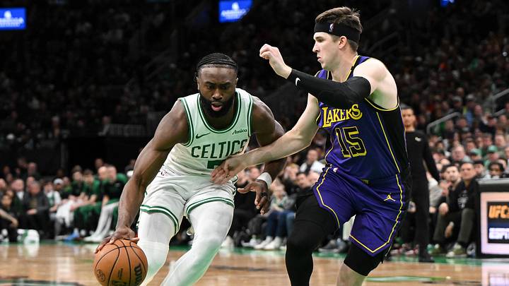 Mar 8, 2025; Boston, Massachusetts, USA; Boston Celtics guard Jaylen Brown (7) drives to the basket against Los Angeles Lakers guard Austin Reaves (15) during the fourth quarter at the TD Garden. Mandatory Credit: Brian Fluharty-Imagn Images