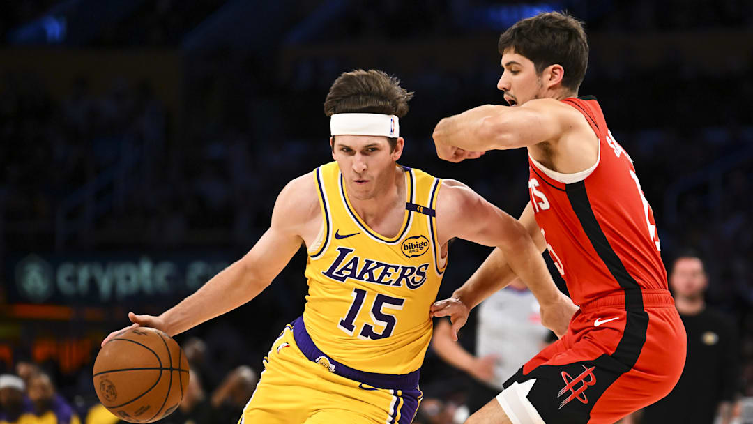 Apr 11, 2025; Los Angeles, California, USA; Los Angeles Lakers guard Austin Reaves (15) drives the ball against Houston Rockets guard Reed Sheppard (15) during the first half at Crypto.com Arena. Mandatory Credit: Jonathan Hui-Imagn Images