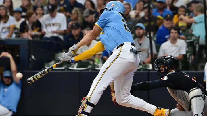 Aug 18, 2024; Milwaukee, Wisconsin, USA; Milwaukee Brewers shortstop Willy Adames (27) hits a single to drive in a run in the first inning against the Cleveland Guardians at American Family Field. Mandatory Credit: Benny Sieu-USA TODAY Sports