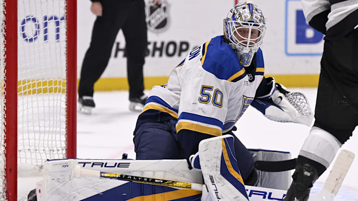Mar 5, 2025; Los Angeles, California, USA;  St. Louis Blues goaltender Jordan Binnington (50) deflects a shot by the Los Angeles Kings during the second period at Crypto.com Arena. Mandatory Credit: Alex Gallardo-Imagn Images