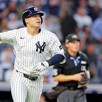 Sep 30, 2025; Bronx, New York, USA; New York Yankees shortstop Anthony Volpe (11) hits a solo home run during the first inning against the Boston Red Sox during game one of the Wildcard round for the 2025 MLB playoffs at Yankee Stadium. Mandatory Credit: Brad Penner-Imagn Images