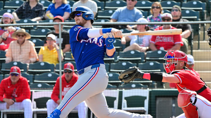 Feb 23, 2026; Tempe, Arizona, USA;  Texas Rangers catcher Danny Jansen (9) hits a two-run home run in the first inning against the Los Angeles Angels during a spring training game at Tempe Diablo Stadium. Mandatory Credit: Matt Kartozian-Imagn Images