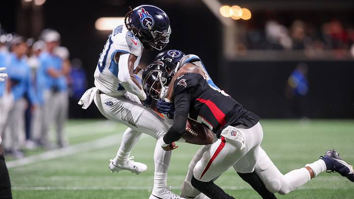 Aug 15, 2025; Atlanta, Georgia, USA; Atlanta Falcons quarterback Emory Jones (15) is tackled by Tennessee Titans cornerback Jermari Harris (30) and linebacker Amari Burney (58) in the fourth quarter at Mercedes-Benz Stadium. Mandatory Credit: Brett Davis-Imagn Images