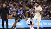 Dec 3, 2025; Orlando, Florida, USA; Orlando Magic guard Jase Richardson (11) drives to the hoop past San Antonio Spurs forward Julian Champagnie (30) in the fourth quarter at Kia Center. Mandatory Credit: Nathan Ray Seebeck-Imagn Images