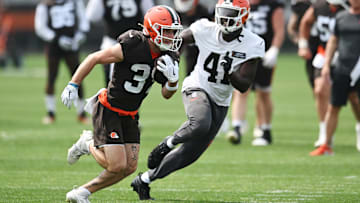 Jun 12, 2025; Berea, OH, USA; Cleveland Browns wide receiver Luke Floriea (37) runs with the ball ask safety Chris Edmonds (41) defends during mini camp at CrossCountry Mortgage Campus. Mandatory Credit: Ken Blaze-Imagn Images