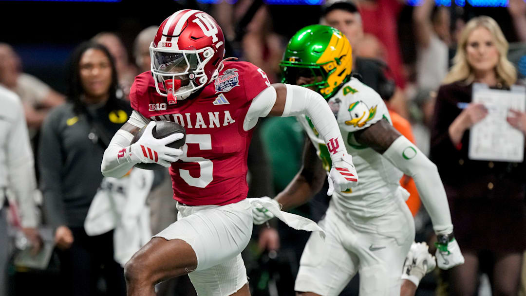 Indiana Hoosiers defensive back D'Angelo Ponds (5) intercepts a pass intended for Oregon Ducks wide receiver Malik Benson (4) and runs it back for a touchdown Friday, Jan. 9, 2026, during the Peach Bowl and semifinal game of the College Football Playoff at Mercedes-Benz Stadium in Atlanta.
