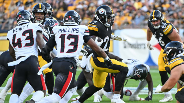 Aug 9, 2024; Pittsburgh, Pennsylvania, USA;  Pittsburgh Steelers running back Najee Harris (22) runs past Houston Texans linebacker Del'Shawn Phillips (13) during the first quarter at Acrisure Stadium. Mandatory Credit: Barry Reeger-USA TODAY Sports