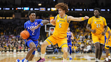 Dec 8, 2024; Columbia, Missouri, USA; Kansas Jayhawks guard AJ Storr (2) drives against Missouri Tigers guard T.O. Barrett (5) during the second half at Mizzou Arena. Mandatory Credit: Jay Biggerstaff-Imagn Images