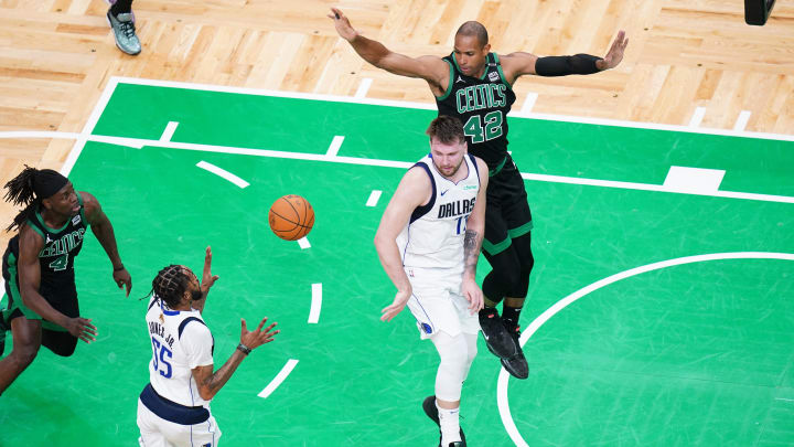 Dallas Mavericks guard Luka Doncic (77) passes against Boston Celtics center Al Horford (42) in the second quarter during game two of the 2024 NBA Finals at TD Garden.